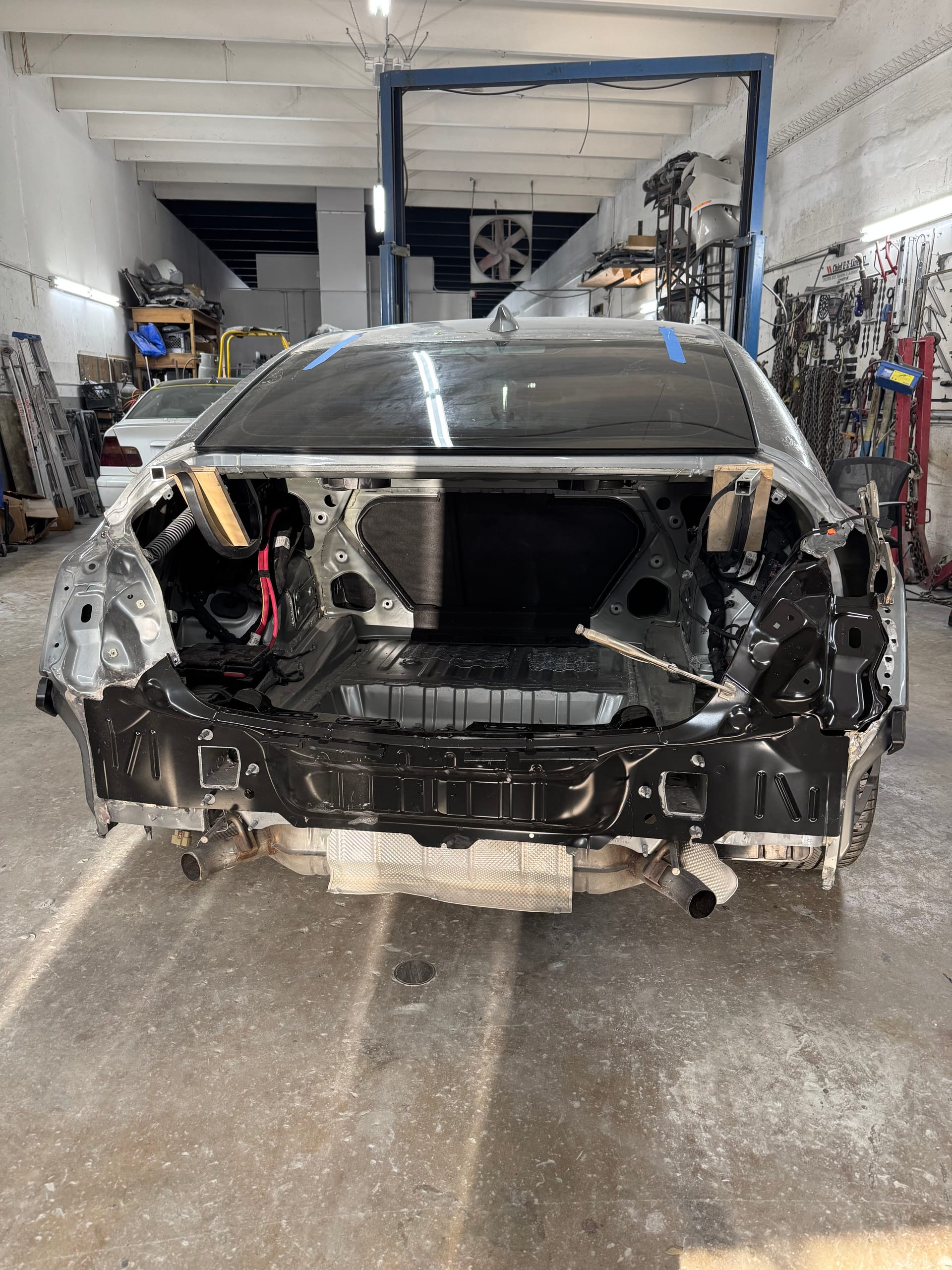 Cadillac CT5 with the rear end stripped to the structure after a collision
