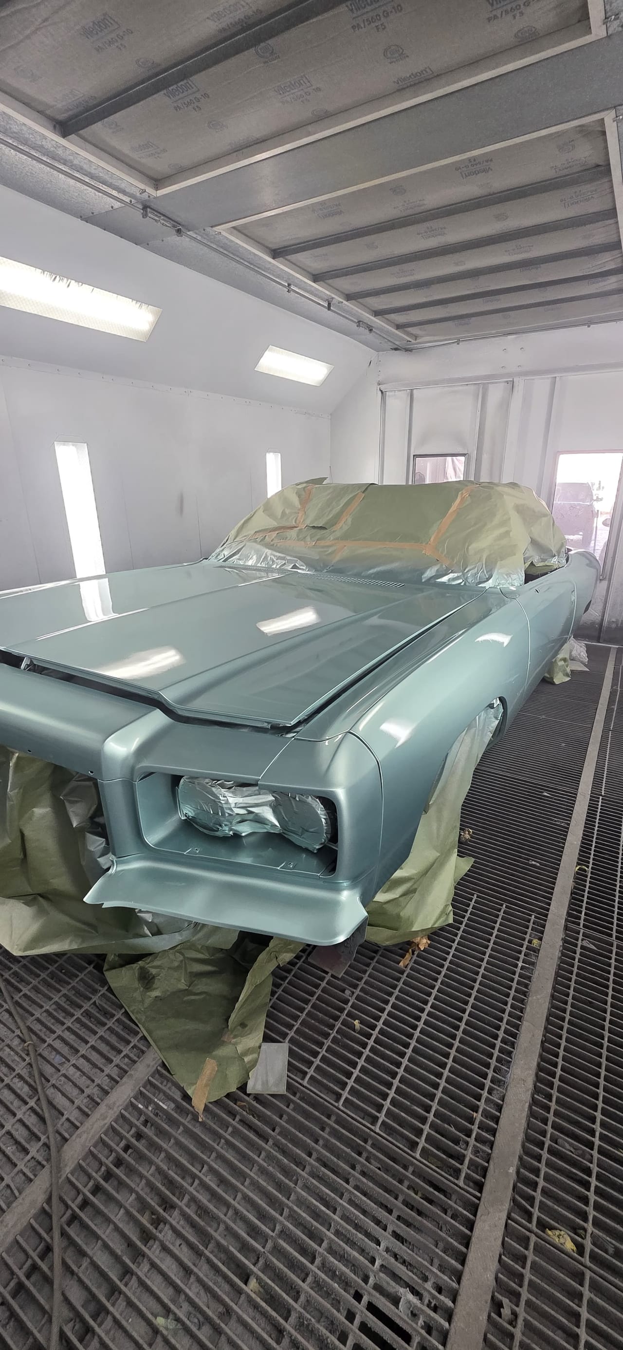 Light blue base coat going on the Malibu in the KAG paint booth