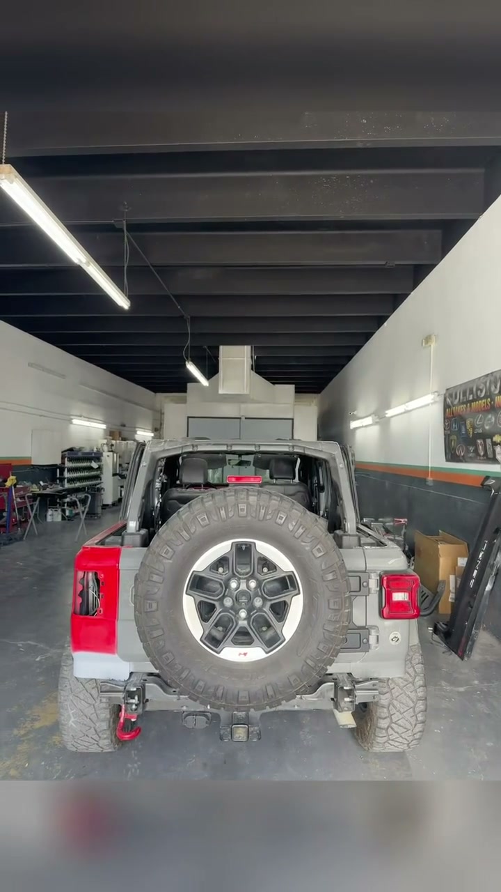 Grey Jeep Wrangler going from a replacement rear quarter panel to masked and painted in the KAG paint booth